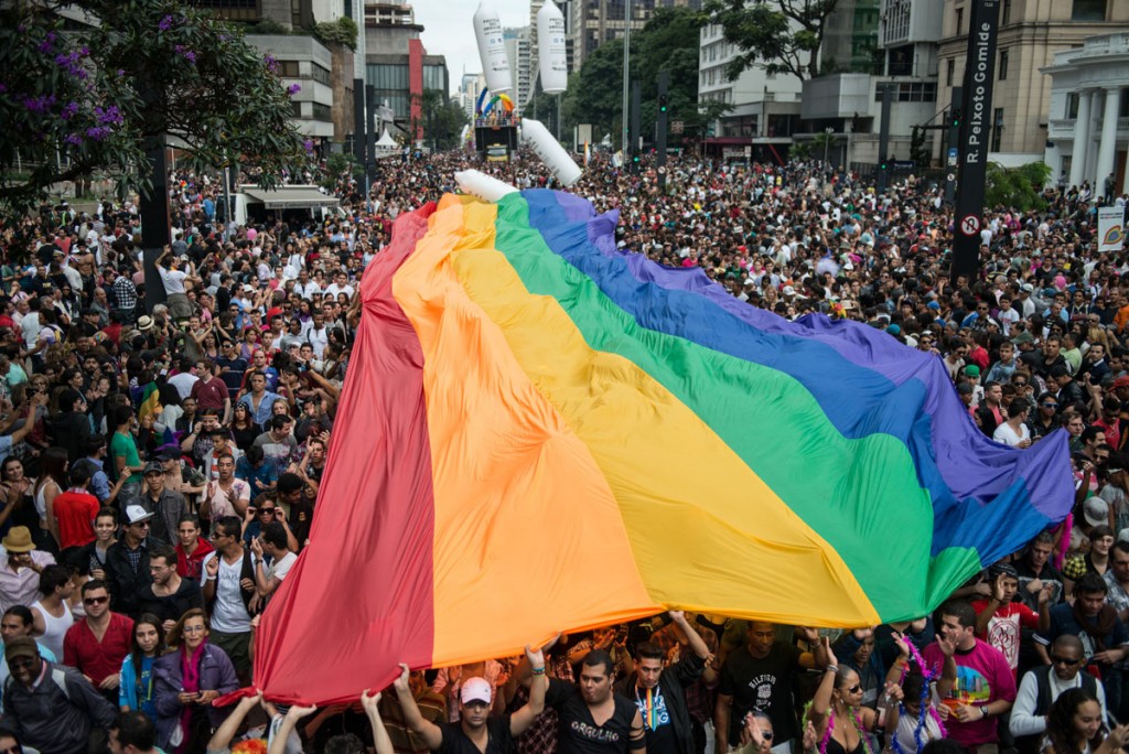 A huge rainbow flag is unfold during the annual gay pride parade in Sao Paulo, Brazil, on June 10, 2012. About 3 million people were expected to take part in the parade under the 2012 theme "Homophobia has cure".  AFP PHOTO/Yasuyoshi CHIBAYASUYOSHI CHIBA/AFP/GettyImages ORG XMIT: